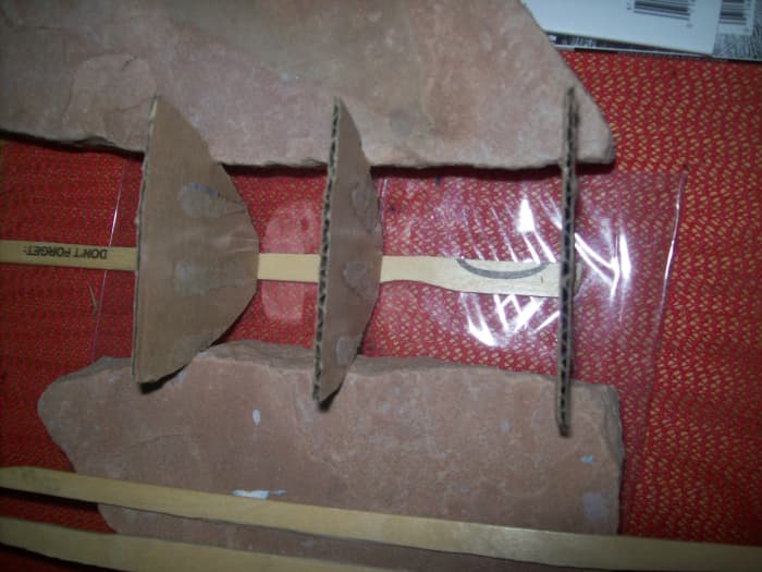 The strips at the bottom of the photo will be glued to the partitions to form the structure of the hull.