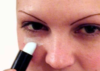 Use a white or green tinted concealer to cover dark under-eye circles. Lightly apply normal make-up over the concealer.