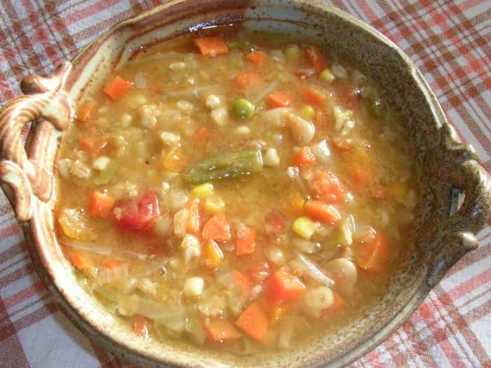 Dried legumes and grains, fresh carrots, onions, and celery, stewed tomatoes, fresh cabbage, and frozen mixed vegetables all cooked in a vegetable stock make this hearty autumn and winter vegetable soup.