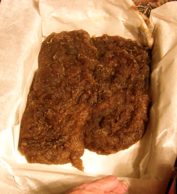 As you can see the consistency of "pourable" soap is more like lumpy heavy mashed potatoes. You will want to spoon it in very quickly and press it down as you go - it's HOT so use wax paper and something sturdy (I use a piece of board) to press it.