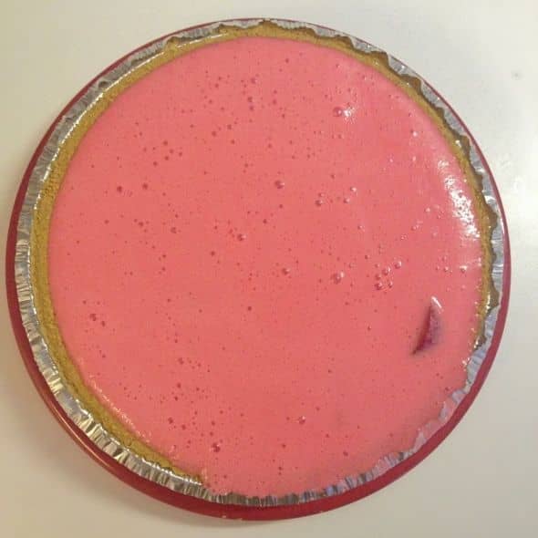 Pour the jello-milk mixture over the strawberries in the tart and place in the fridge.
