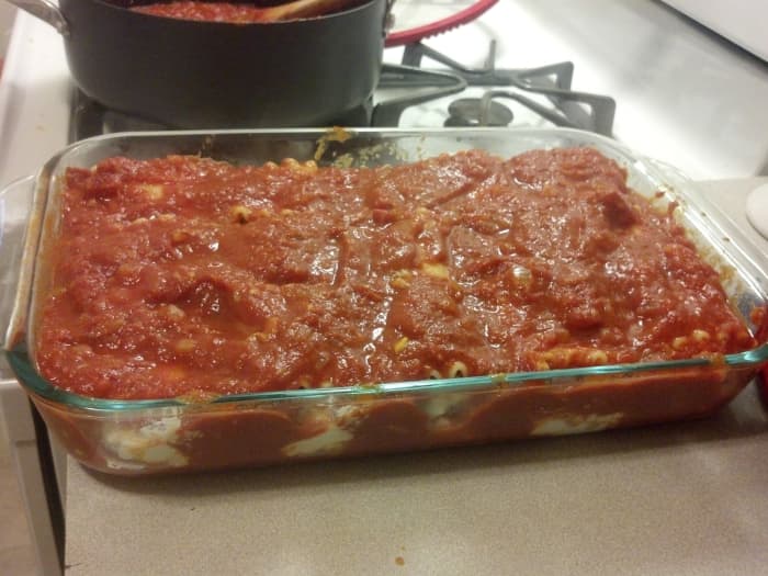 Make sure to cover the lasagna evenly with sauce, and to get it in between the rolls and rows.
