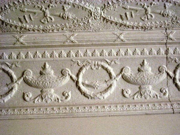This design was in a building in Whitewater, Kansas. It shows how the wall and the ceiling meet with the design carried down to form a border.