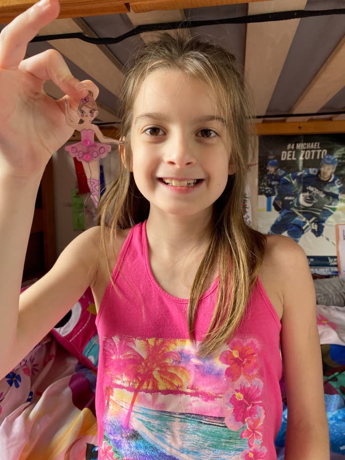 Here, one of my daughters is showing the ballerina ornament she made. You can appreciate the "Shrink" and see the size of the finished product to scale.