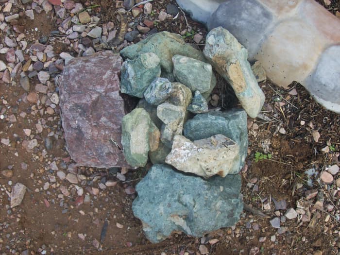 The Lost Esmeralda Mine had a greenish colored ore. Esmeralda means emerald in Spanish. The photo shows green rocks I have found in many Arizona locales.