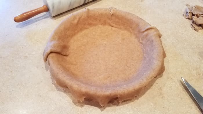 Transfer it over. I usually do this by folding mine in half, and possibly in half again to move it, and then unfolding it into my pie pan. Press into place.