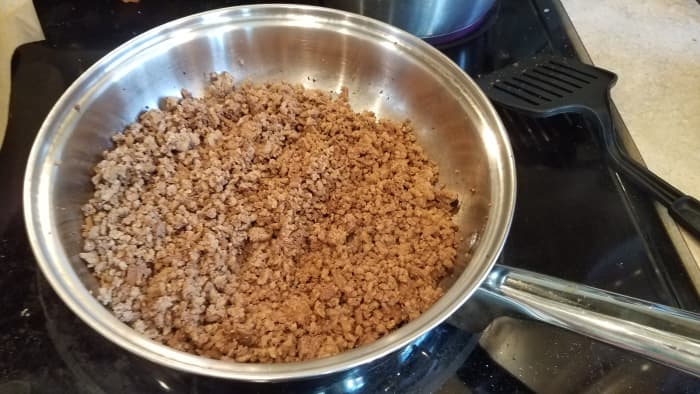 Now get your hamburger cooking in a pan on the stove over medium high heat or so. Chop your onion finely and add it to the mix as well.
