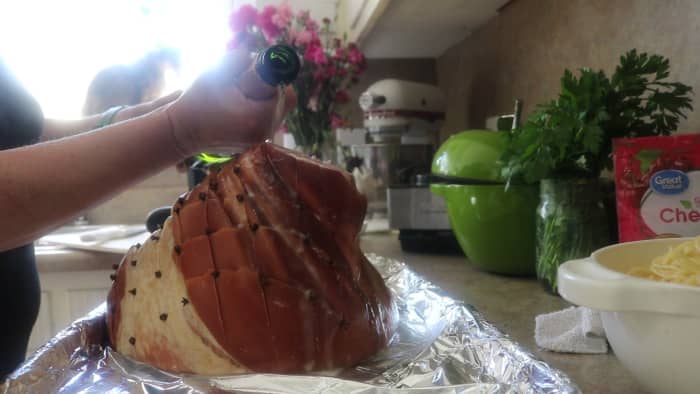 Drizzle the ham with champagne, working slowly and carefully so as not to dislodge the cloves. You only need about a cup or so - a little does the trick!