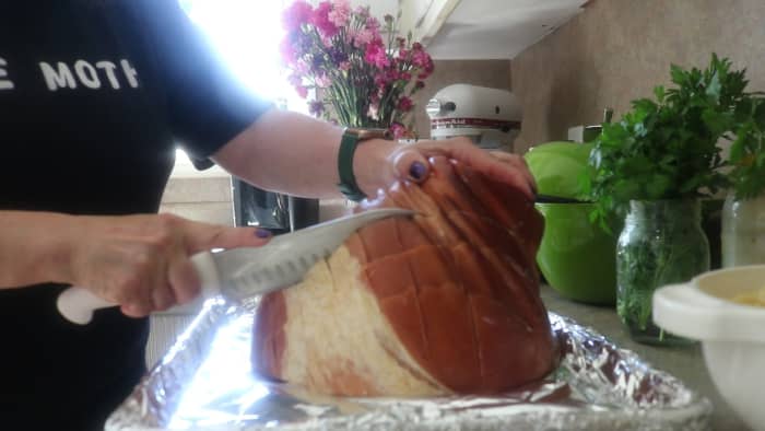 Score the exterior of the ham by first cutting one way, then diagonally in the other direction. This creates a hatch diamond pattern. Place whole cloves at the intersections of each diamond shape.