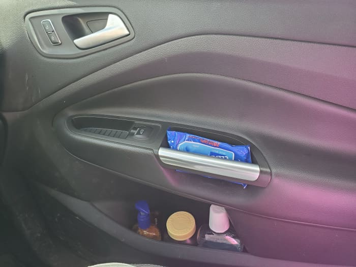 Utilize the car door's storage for frequently used items such as hygiene or medications so that they are easily accessible.