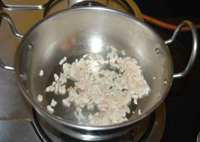 Step three: Heat the oil in a deep-bottomed pan. Saute the chopped onions until they become pinkish.