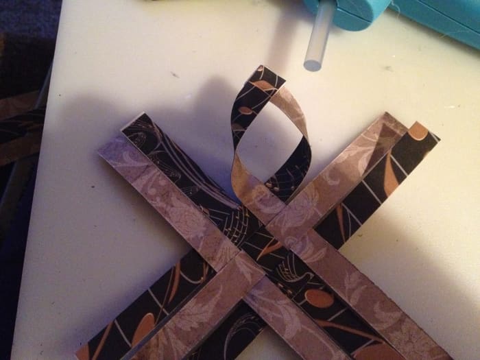 Over lap the ends creating a pointy loop. You'll do this with all four corners on each of the 2 pieces you created.