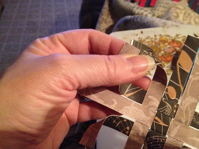 With the sides you've chosen to be the INSIDE facing you, take the two ends of each corner and bring them together to make a point. Hot glue holds these the best.