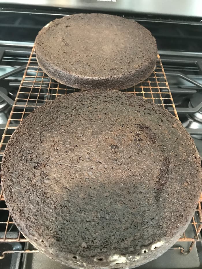 Be patient and allow the cakes to cool all the way before frosting. If you frost too quickly, the warmth will melt the frosting and it'll slide right off, so let them cool all the way down.