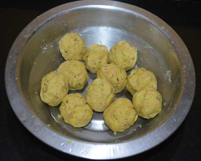 Divide the dough into many equal lemon-sized portions. Shape each portion like a patty. 