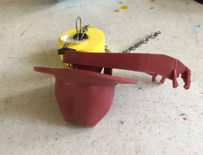It is time to replace this defective flapper-style flush valve. Notice the warped rubber flange.