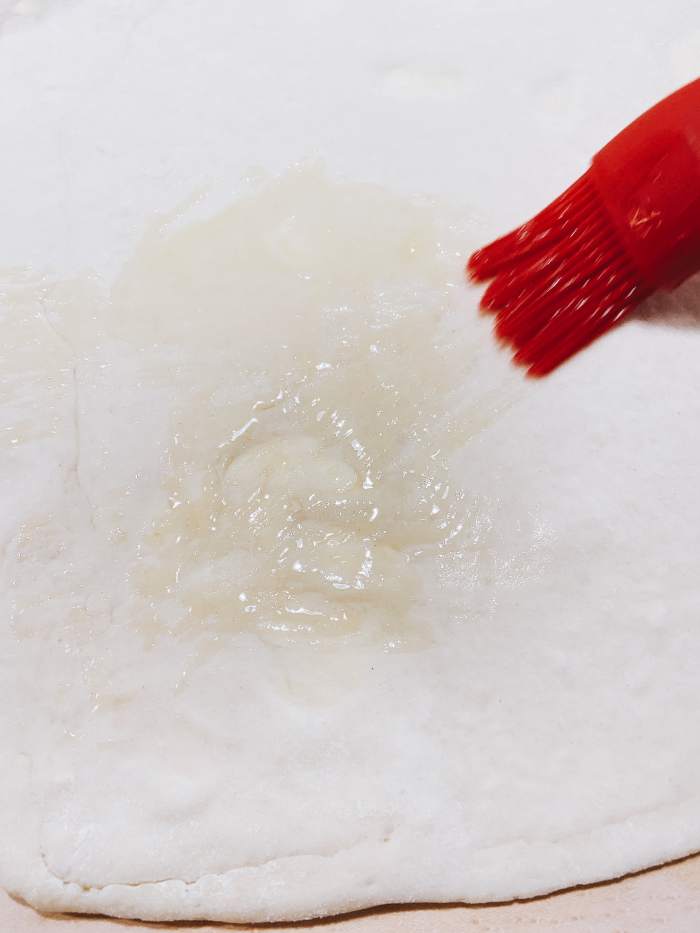 Brush the dough with melted butter. 