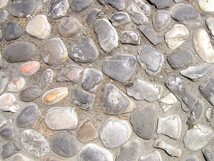 Deriviation of cobble: the diminutive of the archaic English word "cob", meaning "rounded lump", originally referred to any small stone rounded by the flow of water