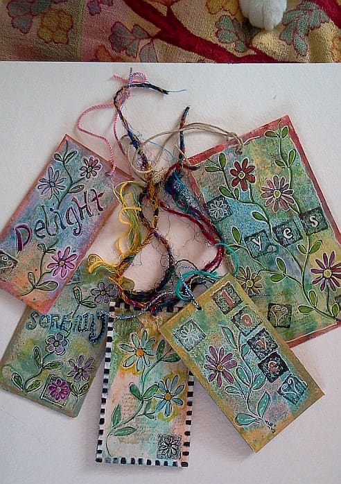 Finished tags... notice the 'helpful' paw coming in from the top—that's our black and white cat, Doodle!