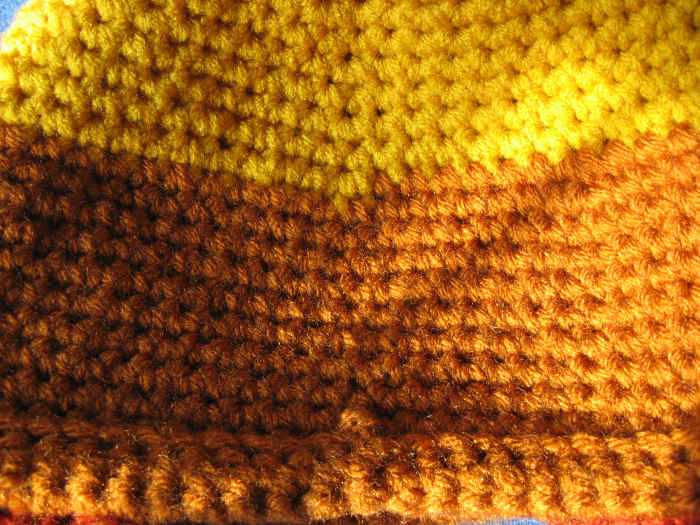 This shows the back of the hat. You can see where the yarn color changes. You can also see that the bottom edge has been folded up (towards outside of hat) and chain-stitched to form a rolled brim.