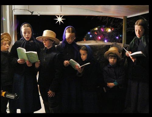 Amish children singing Christmas carols for their non-Amish neighbors. They gave the photographer special permission to take their picture.