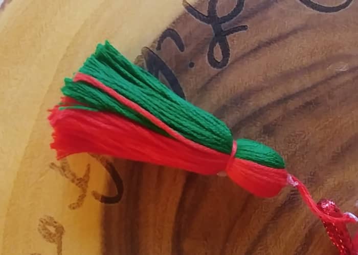 This is a homemade tassel, but tassels can be found in craft stores. This one is a two colored red and green tassel, however the color of tassel is optional.
