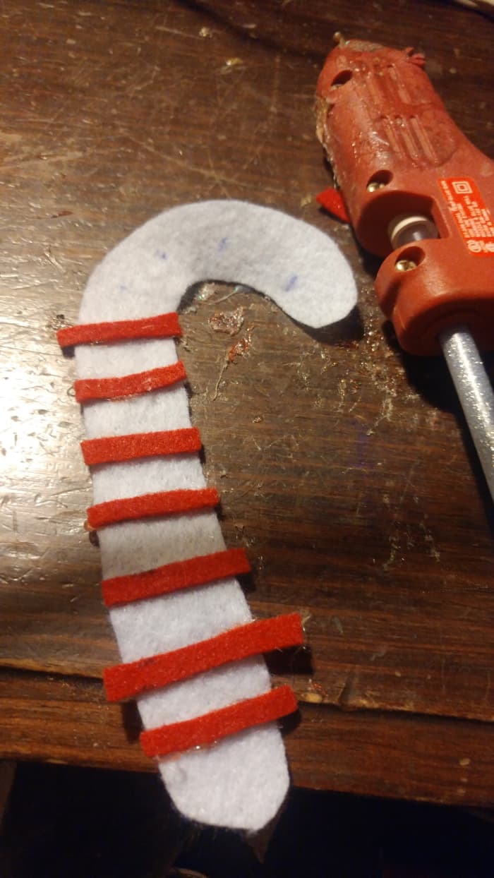 It is alright if the strips are a little too long. After hot gluing them to the white cane, simply trip edges with scissors.