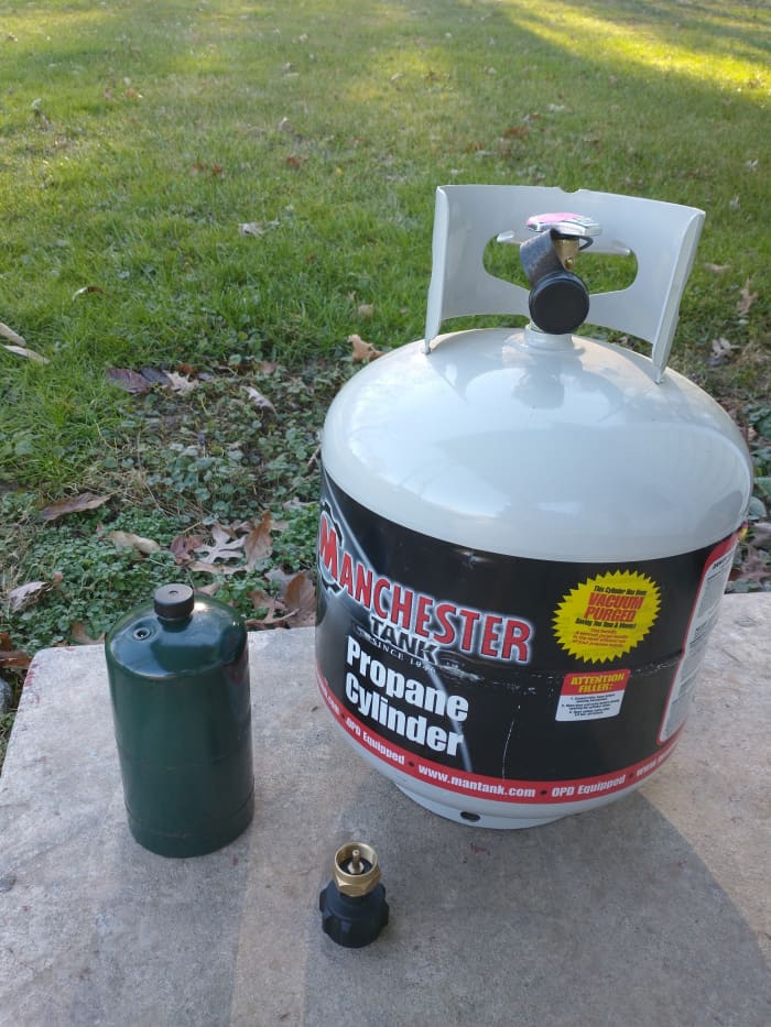 Propane tank, 1 lb. cylinder, and refill adapter.