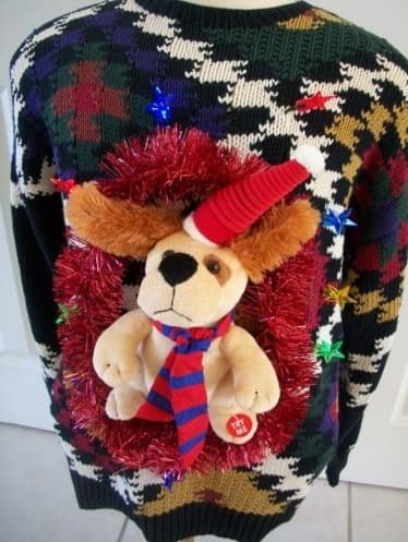 Hint: A Christmas Sweater is not required for the start of your ugly sweater project. Here's a very busy sweater that suggests Christmas only because of the decorations. Like lights, and a puppy wearing a Santa hat and scarf, and a garland wreath.