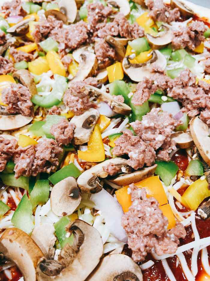 Break up the Beyond Beef patty into small pieces and scatter on the top.