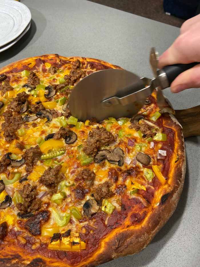Slice the pizza with a pizza cutter and serve.