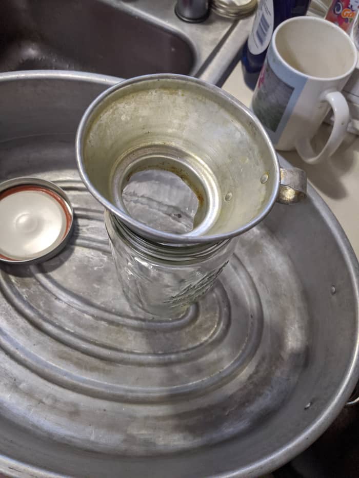 I'm going to use a metal funnel to help dump it into the jars. I had enough to fill a quart jar, and a pint jar. Save the fluid