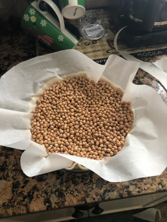 Parbake the individual pie crust shell for 15 minutes. You can use the fancy pie weights if you'd like, but I just use dried garbanzo beans (chickpeas).