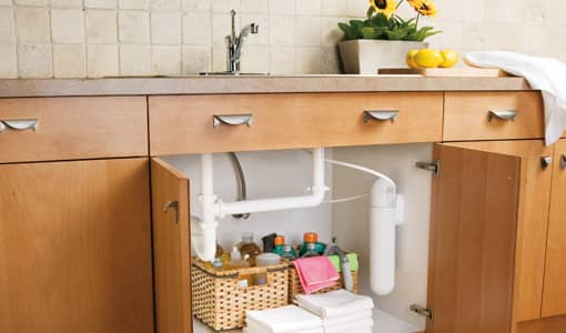 under the sink water filter system shown with water filters hidden from the kitchen countertop