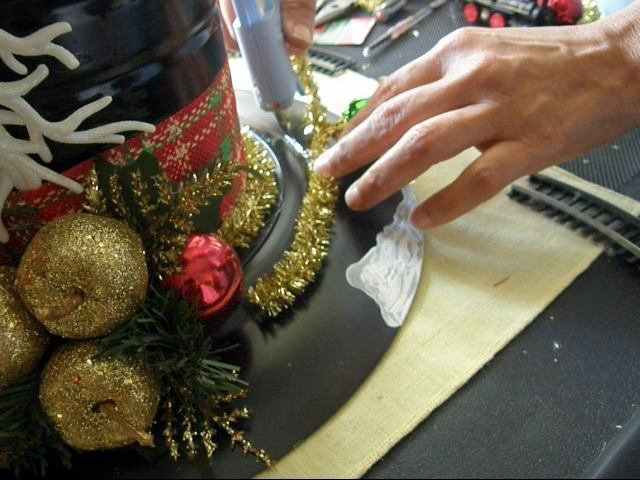 I added some extra tinsel to camouflage the extra lip on the plate. I actually used a charger, and I did not like how this part looked. It worked out well with with the tinsel, plus it gave the design some extra glamour.