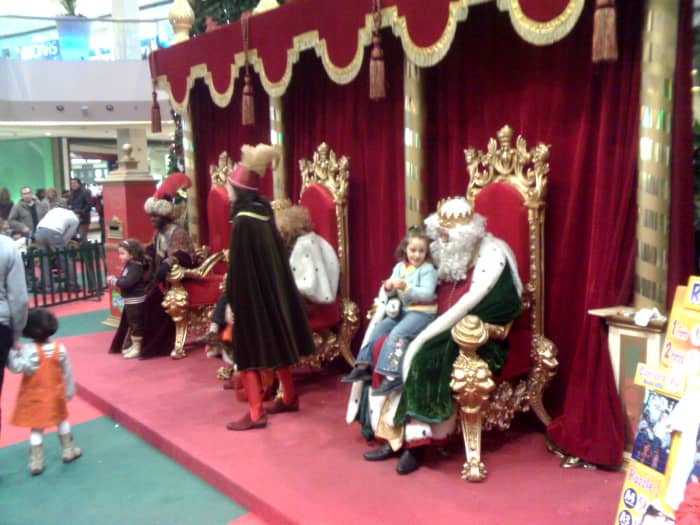 The Three Wise Men receiving children at a shopping centre in Spain. Letters with gift requests are left in the letterbox on the left-hand side.