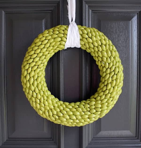 The chartreuse wreath is painted. These caps were taken off the acorns. It is made the winter wreath with a ribbon on the front door.