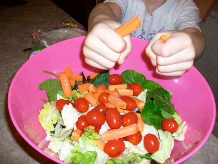 Here's a beautiful green salad made by a child's hands! This article explores salad-making for kids.
