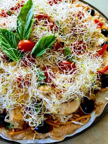 Loaded vegan pizza ready to go into the oven. Unkneaded spelt crust from recipe in "Vegan Pizza: 50 Cheesy, Crispy, Healthy Recipes," by Julie Hasson.
