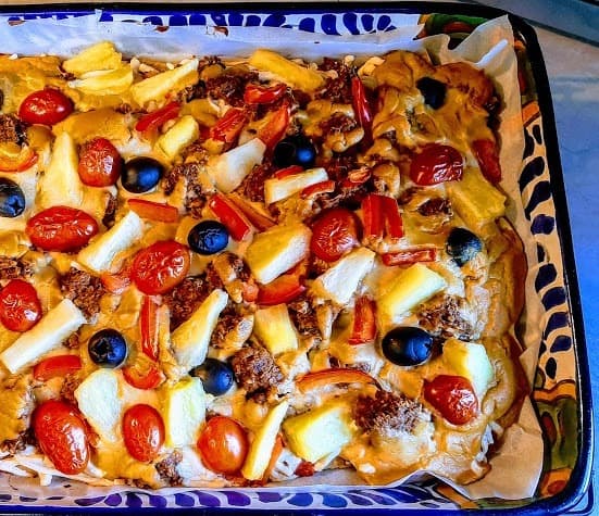 Taco Pizza, from Julie Hasson's "Vegan Pizza," features a Mexican zing! Includes taco "crumbles," tomato sauce on a cornmeal crust, and cheddary cheesy sauce.