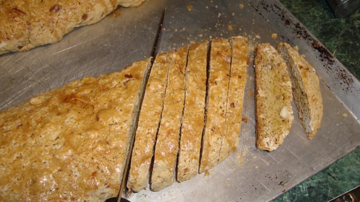 Slicing the slightly cooled logs. The slices in the middle are the longest, due to the angle of the cut.