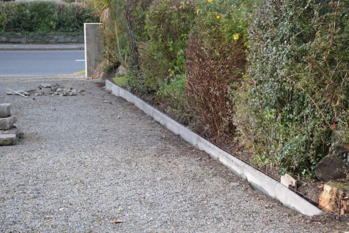 Finished result. A couple of the stones at the far end were a bit off line vertically, but this was my first time doing this. The last stone in the foreground slopes downward at a gap in the row of shrubs.