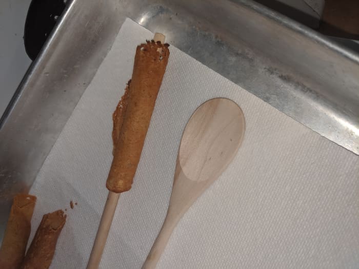 Pick up and move to paper towel lined plate. Do not remove spoon handle. Use two spoons, so you can let one cool while you do another krumkake.