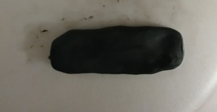 It is easier to choose black polymer clay to shape, but you may choose white clay and then paint black.