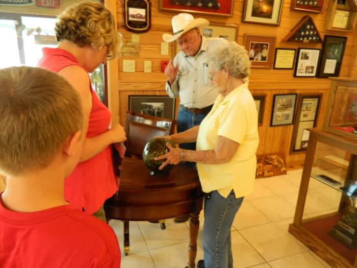 Forrest proudly showing off Nina and her presentation bowling ball from the Partners in Fishing Foundation.