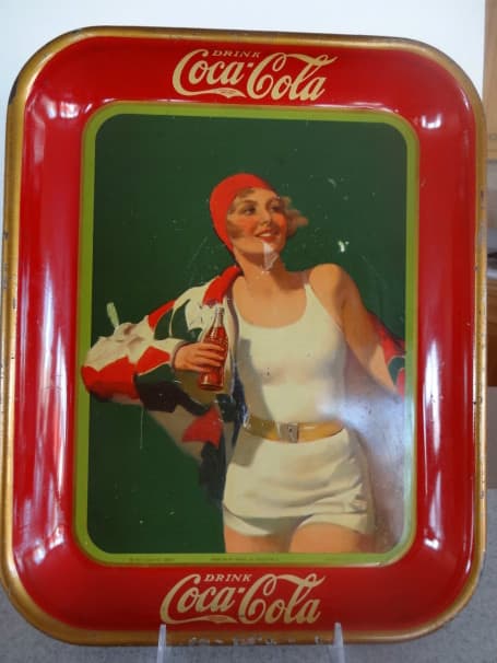 Coca Cola metal tray with blond girl in white swim suit and red swim hat carrying a Coca Cola bottle