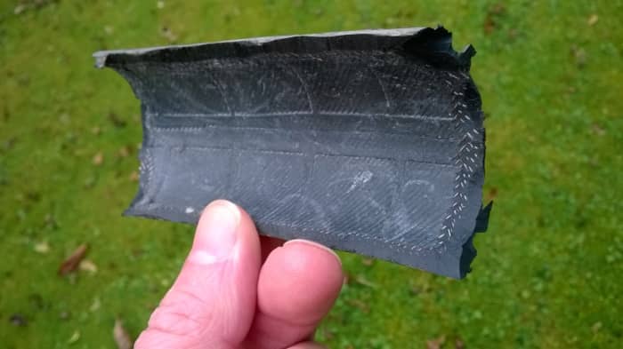 Piece of scrap tire for repairing a blowout. Pare the edges to an acute angle with a knife.