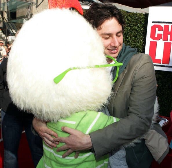 Zach Braff (voice actor for Chicken Little) hugging Chicken Little mascot at the Chicken Little (2005) movie premiere