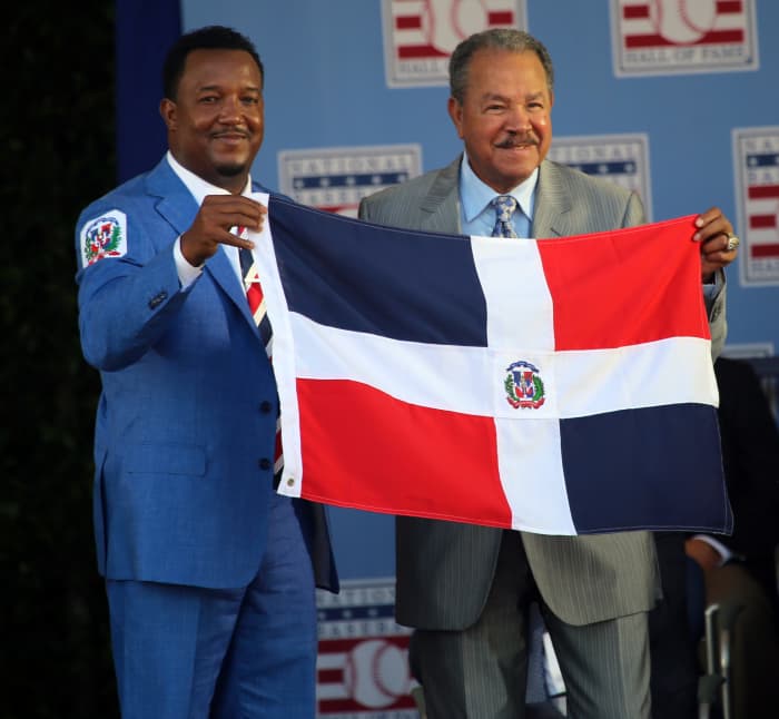 Pedro Martinez (left) and Juan Marichal hold the flag of the Dominican Republic after Martinez became the second native of the island to be inducted to the Hall of Fame. Marichal and Martinez were joined by Vladimir Guerrero in 2018.