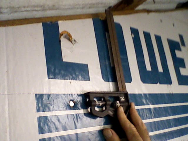 Using a carpenter's square, find the place where the distance from baseline to roofline ("rise") equals the width of your board. Mark it.